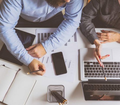 photo-header-table-top-view-of-male-coworkers-analyzing-computer-data